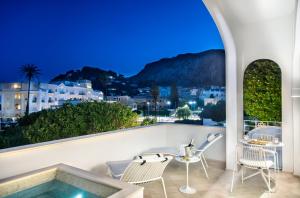 a balcony with a view of a city at Pazziella Garden & Suites in Capri