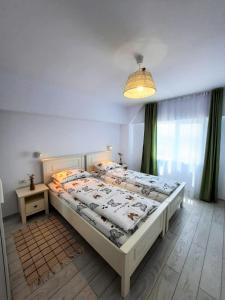 a bedroom with a large bed in a room at Casa Calin in Crisan