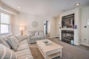 a living room with a couch and a fireplace at Charming Ocean City Townhome Walk to Beach! in Ocean City