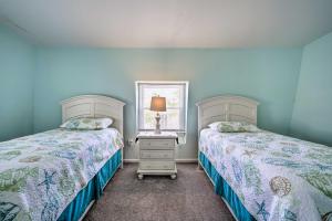 two beds in a bedroom with blue walls at Charming Ocean City Townhome Walk to Beach! in Ocean City
