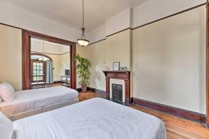 a bedroom with two beds and a fireplace at Charming New Orleans Home Less Than 3 Mi to Bourbon St in New Orleans