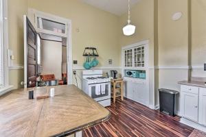 a large kitchen with white cabinets and a wooden floor at Charming New Orleans Home Less Than 3 Mi to Bourbon St in New Orleans
