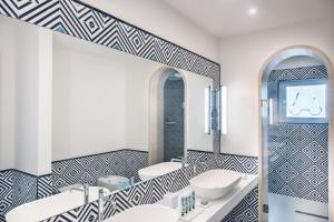 a bathroom with two sinks and a mirror at Pazziella Garden & Suites in Capri