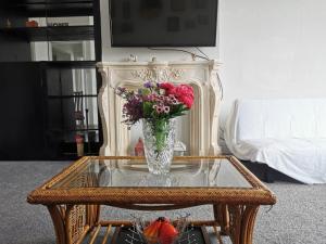 a vase of flowers sitting on a glass table at Victoria's Apartment - 3 Large Bedroom in Blackpool