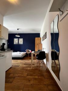 a kitchen and living room with a table and chairs at eM Apartment 17 in Katowice