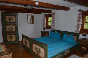 a bedroom with a blue bed in a room at Reitstall Henntalhof in Kitzbühel