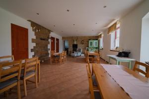 a kitchen and dining room with a table and chairs at Szellő Porta in Szellő