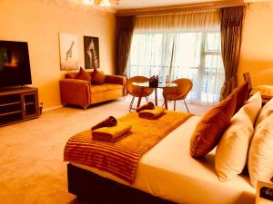 a bedroom with a large bed and a living room at 27A on Angus in Johannesburg