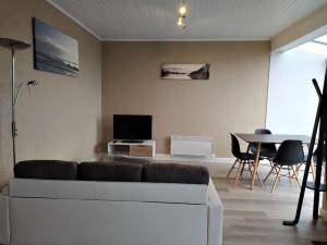 a living room with a couch and a table at Gîtes Merour - Telgruc in Telgruc-sur-Mer