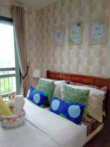 Кровать или кровати в номере ACS Pine Suites Tagaytay