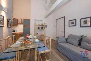 ein Wohnzimmer mit einem Tisch und einem Sofa in der Unterkunft Desenzanoloft Peler in Desenzano del Garda