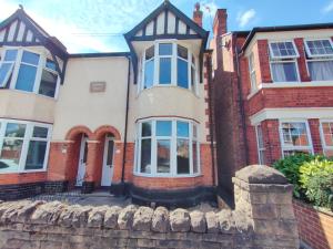 a large brick house with a stone fence at Jasmine Villa B - Ideal for QMC & Uni - Free parking in Nottingham