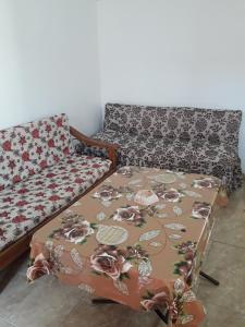 a couch sitting in a living room with a blanket at شقة شاطيء النخيل -بالما كورت in Alexandria +3 photos