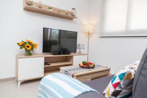 a living room with a flat screen tv on a table at Bahia in Arenales del Sol