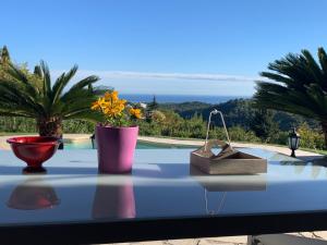 a table with vases and a box on top of it at Villa Linda in Vence
