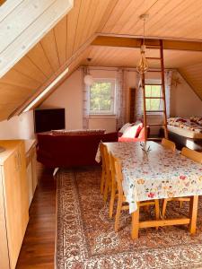 a living room with a table and a couch at Ferienappartement am Almesbach Weiden in Weiden