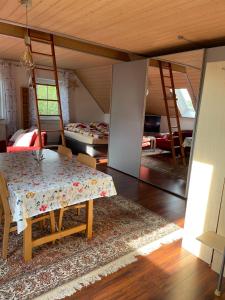 a living room with a table and a bedroom at Ferienappartement am Almesbach Weiden in Weiden