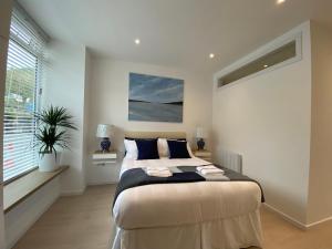 a bedroom with a large bed and a window at Hugmish in Tighnabruaich