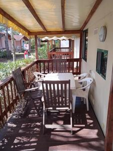 a patio with a table and chairs on a deck at Mobile home Comfort Viareggio - Camping Paradiso- R028 in Viareggio