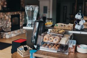 a display of donuts and other pastries on a counter at Sundance Motel in Pinedale