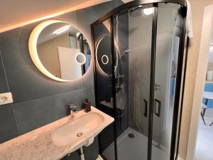 a bathroom with a sink and a shower at Stella Apartments in Kaštela +61 photos