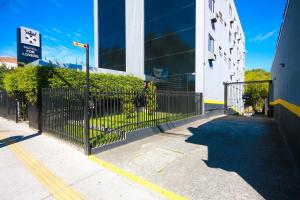 a black fence in front of a building at For Lovers Jabaquara in Sao Paulo