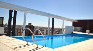 a swimming pool on the roof of a building at AT Suites in Córdoba
