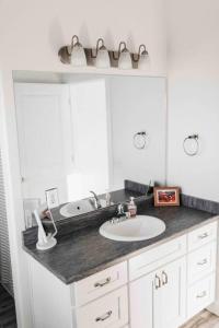 a bathroom with a sink and a mirror at 2 CONDOS next to each other Perfect for GROUPS in Logan