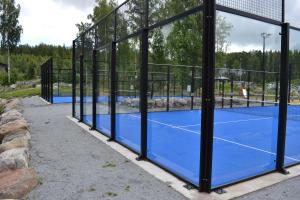 a tennis court with two tennis courts at Comfortable hotel room at Ellivuori Resort in Sastamala