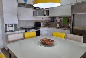 a kitchen with a table with a bowl on it at Areias do Mar | 2 Quartos Garden e Completo A103 in Barra de São Miguel