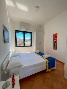 a bedroom with a large bed and a window at La casa di Nettuno in Naples