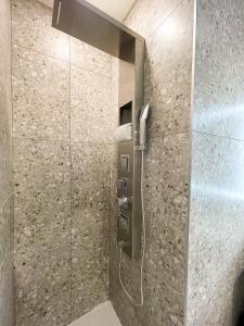 a shower with a glass door in a bathroom at Hotel Saint-Andre in Montreal