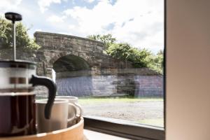 a window with a view of a stone bridge at Off the Track Getaway, Luxury Lodge in Crail