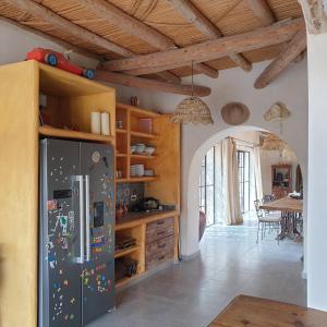 a kitchen with a refrigerator with magnets on it at Slow Luxury at the Serai in Essaouira