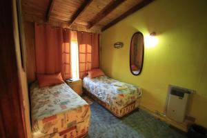 a room with two beds and a window in it at B&B Nahuel en Ushuaia in Ushuaia