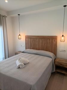 a bedroom with a bed with a towel on it at El SUEÑO DE LA MANCHA in Mota del Cuervo
