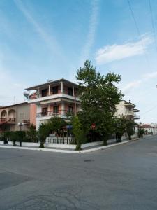 a large building on the side of a street at Villa Moras in Paralia Katerinis