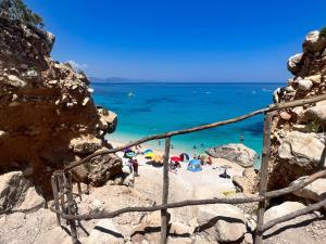 a group of people on a beach with the ocean at Su Saucu in Dorgali