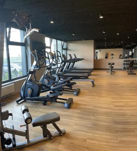 a gym with a row of treadmills and machines at Polanki Aqua A204 in Kołobrzeg