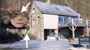 a stone house with a sign in front of it at Maison Castor in Vresse-sur-Semois