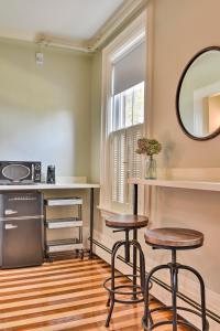 a kitchen with two stools and a mirror at The Burrell House in Keene
