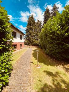 a brick path in front of a house at Ferienwohnung mit Sauna am Wald - Eifel in Kommern
