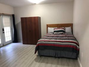 a bedroom with a bed with a striped blanket at Spacious Unit with Mountain View in New Market