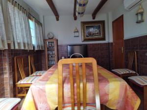 a dining room with a table and chairs and a table at Elche Holidays in Elche