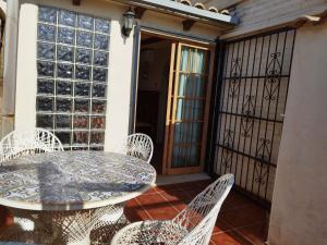 a patio with a table and chairs on a balcony at Elche Holidays in Elche