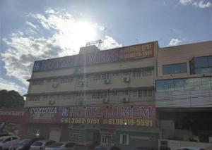 a building with a lot of signs on it at Hotel Lumem Taguatinga Norte in Taguatinga