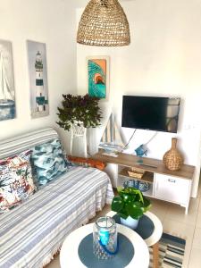 a living room with a couch and a table at Casa La Galera (Playa a 50 metros) in Corralejo