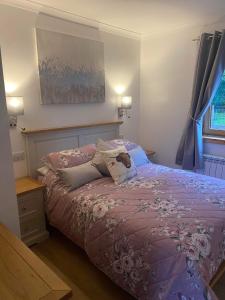 a bedroom with a bed with a purple comforter at Ben Nevis Manor Lodge & Indoor Private Hot-Tub in Fort William