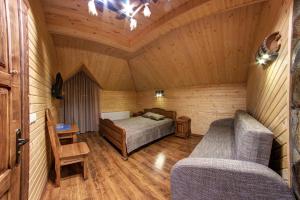 a bedroom with a bed and two chairs in a room at Lavina Hotel in Bukovel