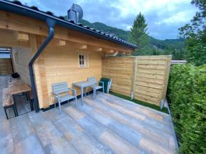 a deck with a table and chairs on a house at Group Stay near Bangerpark in Scharnitz